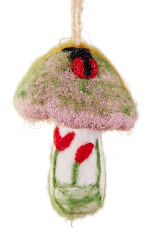 Felted mushroom ornament with a ladybug on a green background